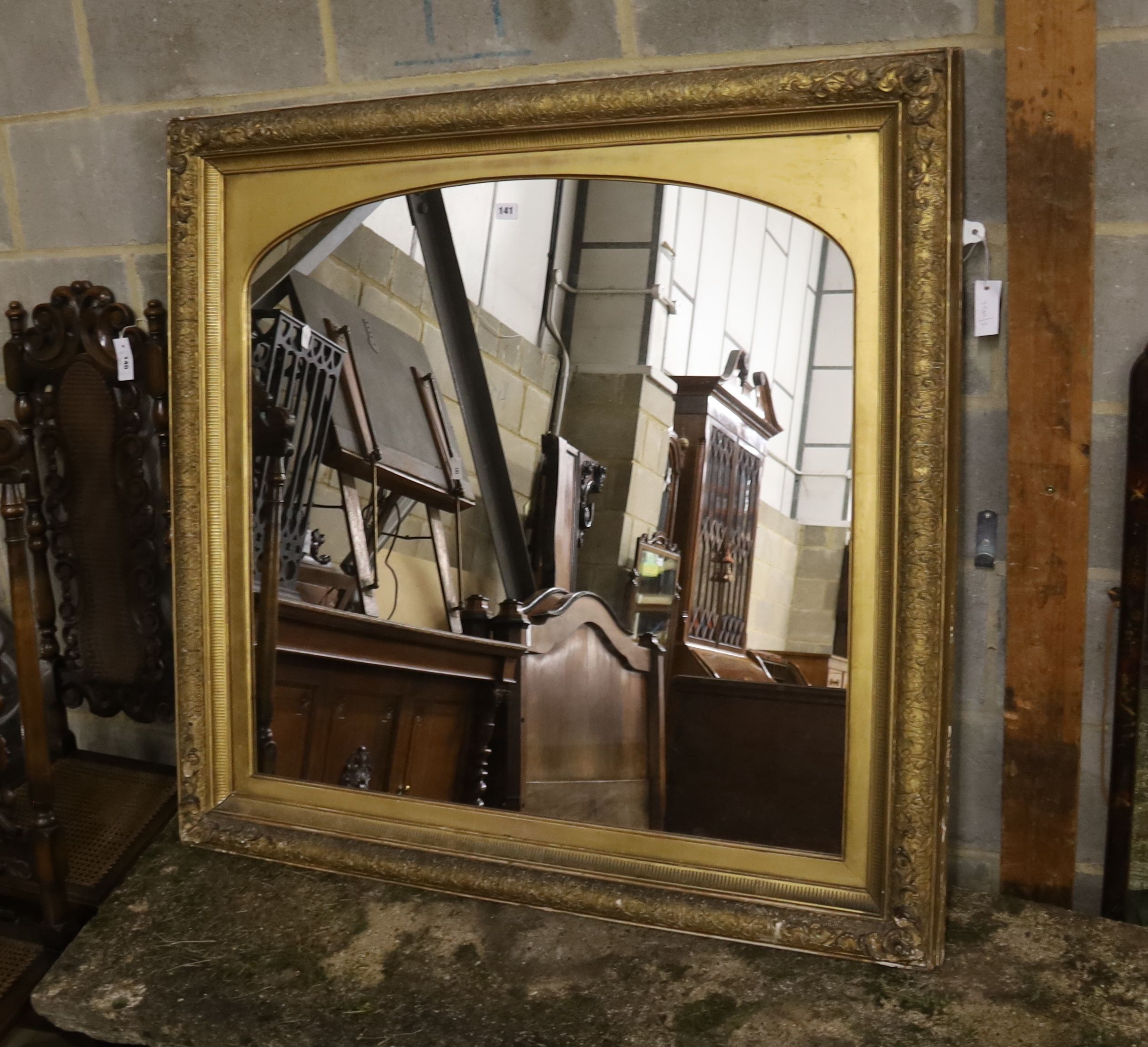 A giltwood and gesso overmantel mirror with arched plate, width 115cm, height 112cm